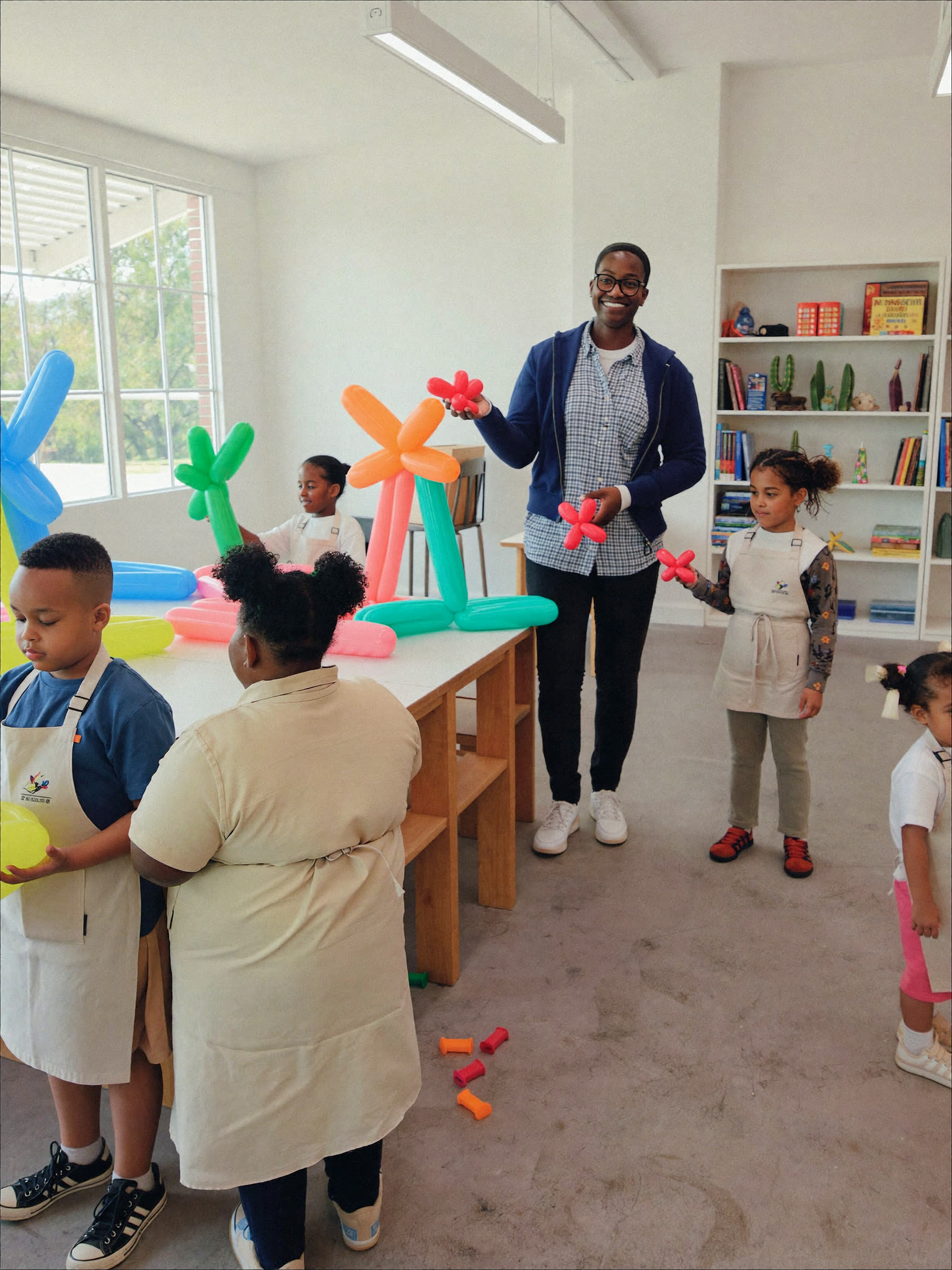Children in joyful balloon play at The Black-E studio